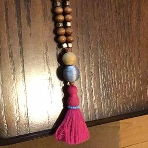 Brown wooden beaded and gold tassel necklace.